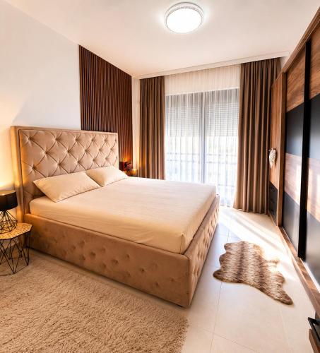 a bedroom with a large bed and a large window at Villa Hana in Bar