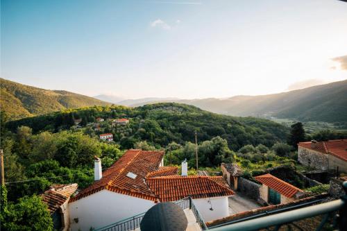 a view of a village with mountains in the background at Valaes Guest House in Foiníkion