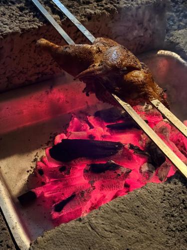 a piece of meat sitting on top of a table with chopsticks at Gandhara Tent camping in Vagamon