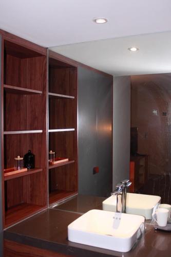a bathroom with two sinks and a mirror at Casahindout in Hanoi