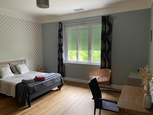 a bedroom with a bed and a window at Chambres et table d'hôtes Le Pontet in Arthès