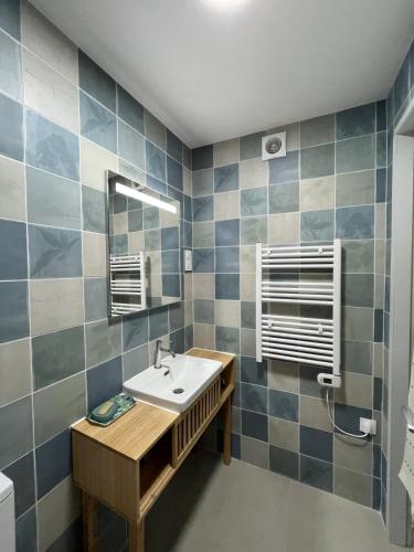 a bathroom with a sink and a mirror at La maison colimaçon in Clans
