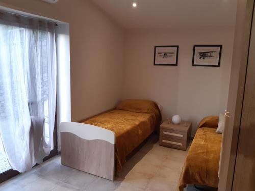 a small bedroom with a bed and a window at Tenuta Mazzotti in Lago