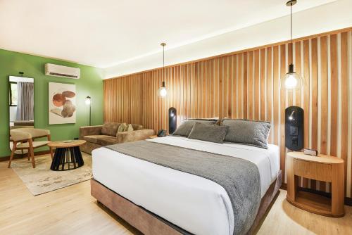 a bedroom with a bed and a living room at Blues Suites Medellín in Medellín