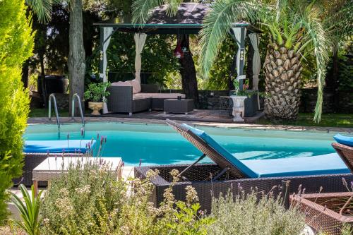 a swimming pool in a yard with a gazebo at Villa Euphoria in Theológos