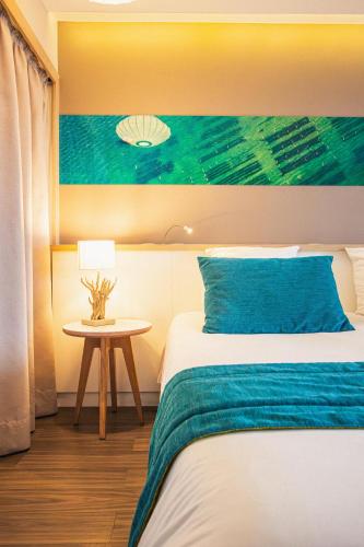 a hotel room with a bed and a table at Hôtel Le B d'Arcachon by Inwood Hotels in Arcachon