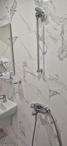 a bathroom with a shower and a sink at Guest House Nash Dom in Kavarna