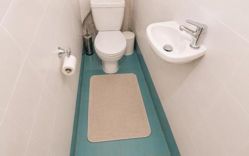 a small bathroom with a toilet and a sink at E&M Villa Sea View in Polychrono