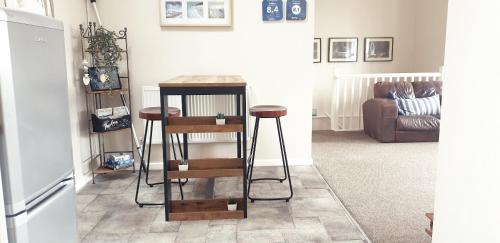 a kitchen with a table and stools in a room at Southcourt in Worthing