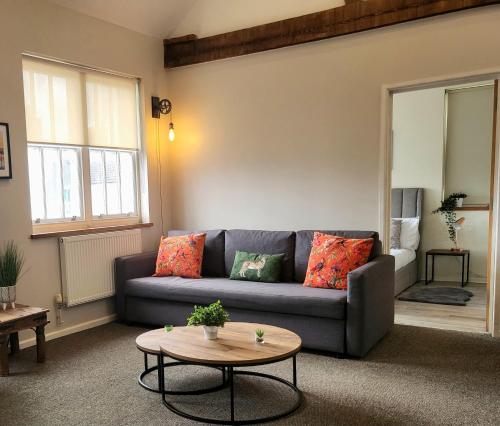 a living room with a couch and a table at Southcourt in Worthing