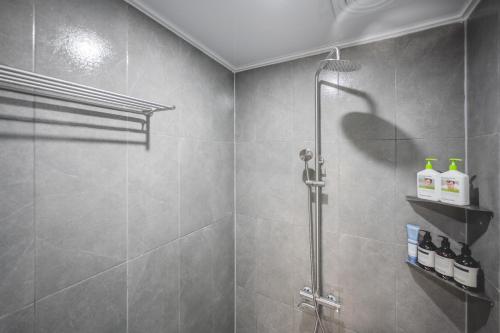 a bathroom with a shower with a glass door at 지니스테이 in Millak-tong