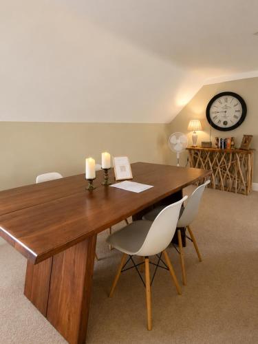 a wooden table with two candles and two chairs at The Lodge at Broadway in Broadway