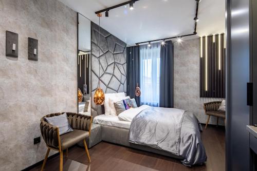 a bedroom with a bed and a chair at Super Central - Modern & Luxury in Budapest