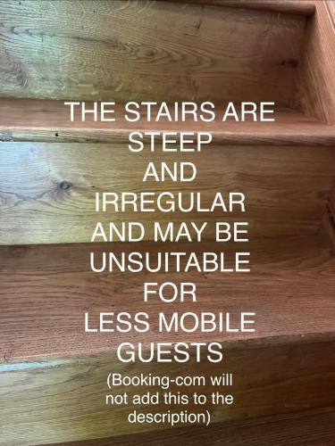 a set of stairs with the words the stairs are step and irregular and may be at Bell Cottage by Ludlow Castle with onsite parking in Ludlow