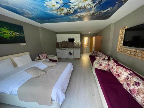 a bedroom with two beds and a painting on the ceiling at Osmanlı Suite in Uzungöl