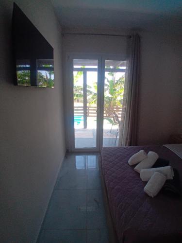 a bedroom with a bed with two towels on it at Elysian Suites in Ratzaklíon