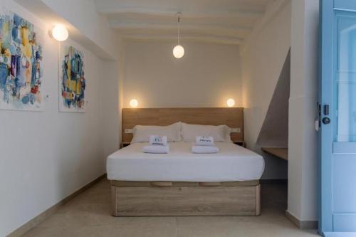 a bedroom with a bed with two towels on it at Artemaris by Seaward Suites in Villajoyosa