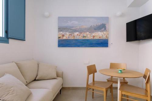 a living room with a couch and a table at Artemaris by Seaward Suites in Villajoyosa