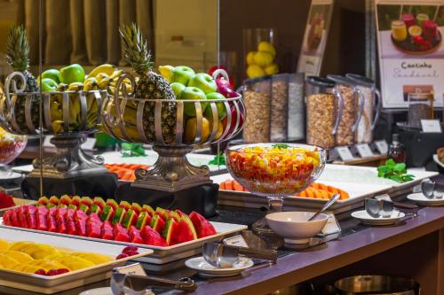 a buffet of fruits and vegetables on a table at Planalto Bittar Hotel e Eventos in Brasília