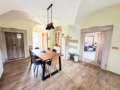 a dining room with a wooden table and chairs at Apartmán 56 in Božanov