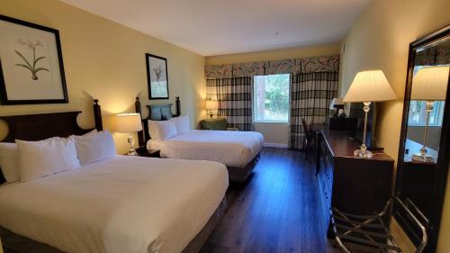 a hotel room with two beds and a window at Plantation Resort on Crystal River in Crystal River