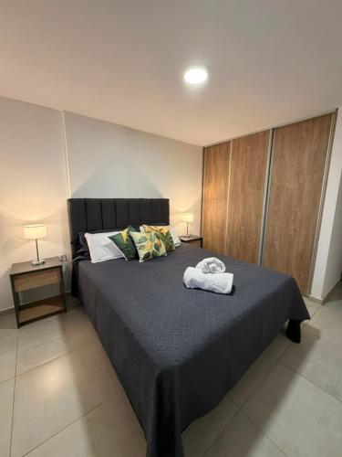 a bedroom with a bed with two towels on it at Amalfi Apart in Villa María