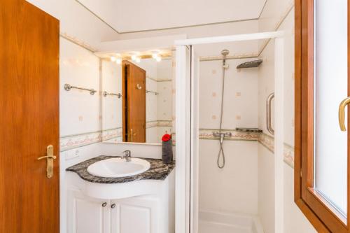 a bathroom with a sink and a shower at Villa Estrella in Cala en Blanes