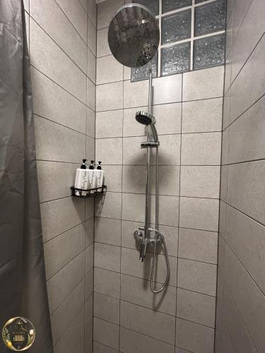a bathroom with a shower with a shower head at Ural Home in Székesfehérvár