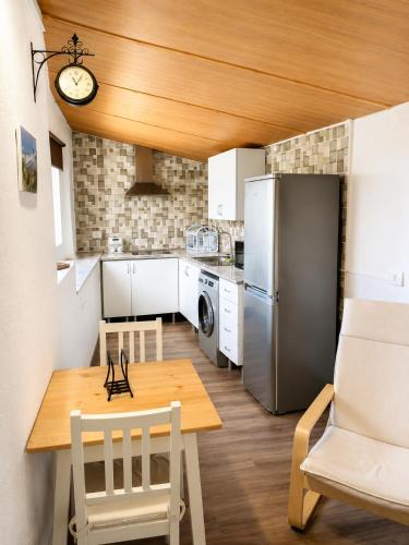 a kitchen with a table and chairs and a refrigerator at TenoHomes La Era de Catuja Getaway in Los Realejos