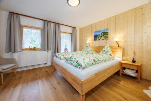 a bedroom with a large bed and a window at Ferienhaus Hallweger inkl. Chiemgaukarte in Ruhpolding