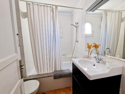 a bathroom with a sink and a toilet and a shower at Teguisol Breeze en Costa Teguise in Costa Teguise