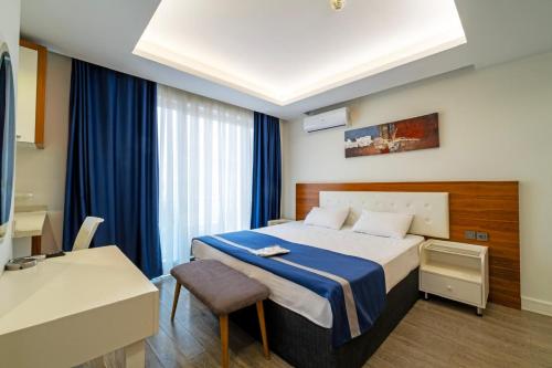 a hotel room with a bed and a chair at Hey Lara Hotel in Antalya