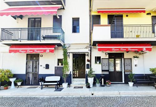 a building with red awnings on a street at Casa Vacanze VENER - Venosa in Venosa