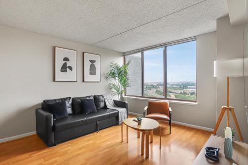 a living room with a black couch and a table at Relaxing Arlington Apt - Pool - near Pentagon City in Arlington