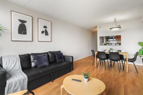 a living room with a black couch and a table at Relaxing Arlington Apt - Pool - near Pentagon City in Arlington