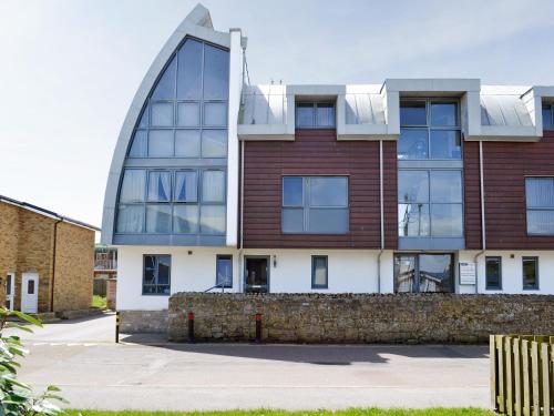 a large building with a curved roof at Sea Drift in West Bay