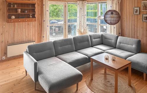 a living room with a couch and a table at Gorgeous Home In Græsted With Sauna in Græsted