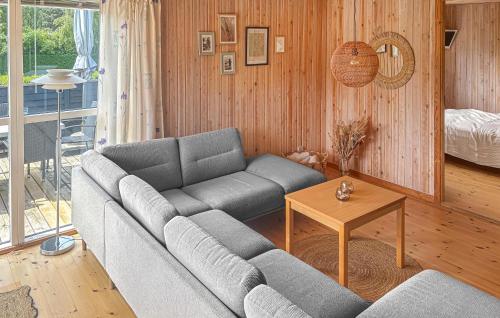 a living room with a couch and a table at Gorgeous Home In Græsted With Sauna in Græsted