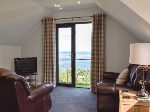 a living room with a view of the ocean at Woodlea Cottage 1 in Dippin