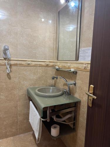 a bathroom with a sink and a mirror at Hotel Ibiza in Eforie Nord