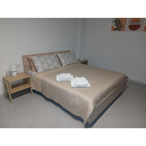 a bedroom with a bed with two towels on it at Dolcecasa in Misilmeri