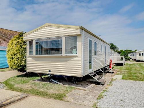 a mobile home is parked in a yard at Sunshine & Smiles in South Hayling