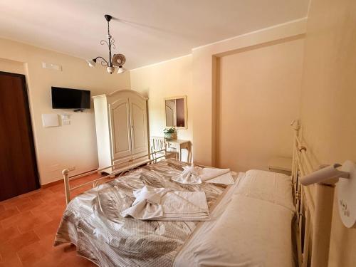 a bedroom with a large bed in a room at Agriturismo Il Vecchio Carrubo in Castellammare di Velia