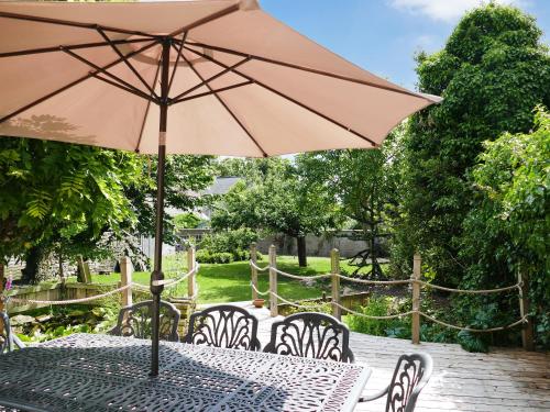 a table with an umbrella on a patio at Rose Croft in Pickering