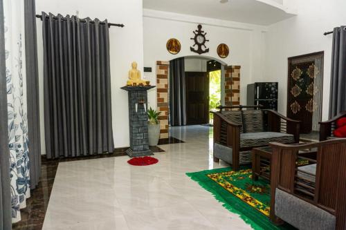 a living room with a couch and a fireplace at River Island Villa in Ahangama