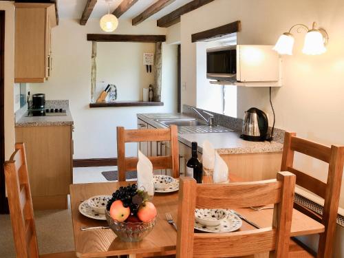 a kitchen and dining room with a table and chairs at Swaledale Cottag in Caldbeck