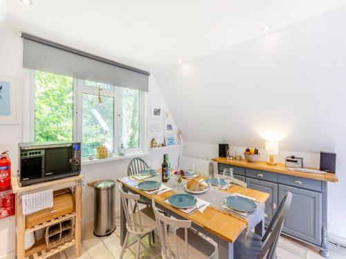 a kitchen with a table with chairs and a microwave at Valley Lodge - Uk49228 in Gunnislake