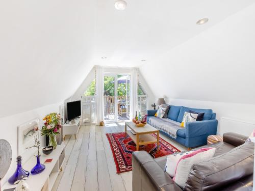 a living room with blue couches and a tv at Valley Lodge - Uk49228 in Gunnislake