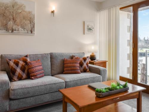 a living room with a couch and a table at Swan House in Carnforth