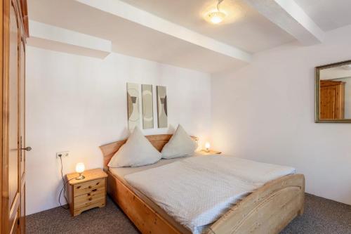 a bedroom with a bed with two lamps on it at Ferienwohnung Coerdt Sauerland in Olsberg